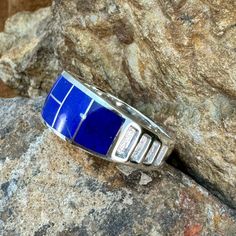 This beautiful Sterling Silver Ring, as part of the Blue Water collection, features Royal Lapis & Denim Lapis. Ring Width: 3/8"; Ring Shank: 1/4" The ring is designed by David Rosales, one of the finest contemporary Southwest Artists in the world. He is the founder and co-owner of Supersmiths, Inc. of Gallup, NM. Each ring is custom made and carries a lifetime guarantee. Contemporary Southwest, Black Arrow, Water Collection, Lapis Ring, Ring Shank, Southwest Jewelry, Jewelry Designer, Blue Water, American Made