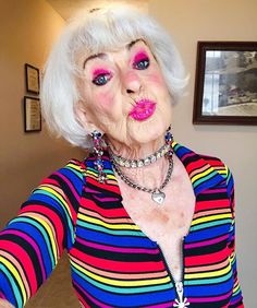 an older woman with white hair and pink lipstick