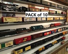 there are many toy trains on display in the store's wall rack, and one is for sale