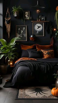 a black bedroom with lots of plants and pictures on the wall above the headboard