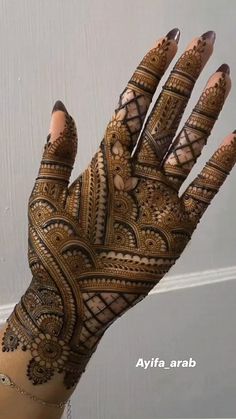 a woman's hand with hennap on it, showing the intricate design