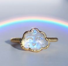 Rainbow moonstone clouds with little smiling faces are electroformed with your choice of copper, ultra thick tarnish free 14k gold or fine silver, creating a super cute kawaii style crystal ring. Each ring is made by hand and electroformed for 12 hours, allowing a unique copper design to develop and encase the stone. Rings are then buffed, polished and sealed with a protective layer to maximize luster, keep the bright and clean rose gold tone, and prevent potential tarnishing and skin discolorat Cloud Jewelry, Kawaii Ring, Rainbow Moonstone Engagement Ring, Cloud Ring, Rainbow Moonstone Jewelry, Face Ring, Copper Design, Rainbow Rings, Smiling Faces