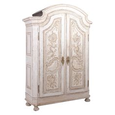 an antique white armoire with ornate carvings