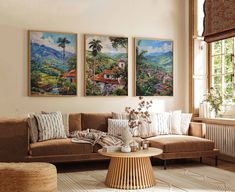 a living room with three paintings on the wall