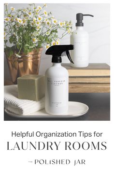 a bottle of liquid and soap sitting on a plate next to a vase with daisies