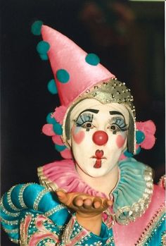 a close up of a person wearing a clown mask