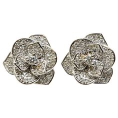 A stunning pair of 18-karat white gold earrings masterfully created entirely by hand. These dainty flowers feature beautiful, organically-shaped petals that are pavé-set with diamonds rated G VS. A perfect gift for Valentine's Day. The earrings are 15 millimetres across. Together they weigh 6.90 grams. They feature postbacks. All FANCS V’s gold pieces are stamped the company code PA266, which indicates the work was done entirely at the studio in Palermo, Sicily. Are you looking for a set? Our pi Luxury Elegant Flower Shaped Diamond Earrings, Luxury Gold Flower Shaped Diamond Earrings, Luxury Elegant Diamond Earrings In Flower Shape, Luxury Diamond White Flower Earrings For Anniversary, Luxury Diamond Flower Shaped Earrings For Women, Luxury Flower Earrings With Diamond Accents For Formal Occasions, Luxury Diamond White Flower-shaped Jewelry, Luxury Diamond White Gold Flower Earrings, Luxury White Gold Flower-shaped Earrings