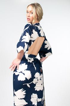 Introducing the Kazu Dress, a captivating design crafted with meticulous attention to detail. Made in a beautiful blue and cream floral print, it features a wrap-around bodice that creates a flattering and adjustable fit, embracing every body type. The straight-line skirt flows effortlessly, lending an air of elegance to your every step, while the bareback design with its arched detailing adds a touch of sensuality. Completing the look, the kimono sleeves provide a hint of relaxed refinement and Elegant Floral Print Wrap Maxi Dress, Elegant Wrap Dress With Floral Print And Surplice Neckline, Elegant Floral Wrap Dress With Surplice Neckline, Elegant Spring Wrap Dress With Tie Back, Chic Wrap Dress With Kimono Sleeves For Spring, Chic Spring Wrap Dress With Kimono Sleeves, Fitted Wrap Dress With Kimono Sleeves For Summer, Fitted Summer Wrap Dress With Kimono Sleeves, White Dress With Floral Print And Kimono Sleeves