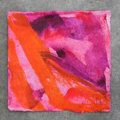 an orange and pink abstract painting on cement