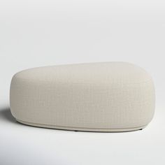 a white ottoman sitting on top of a white floor