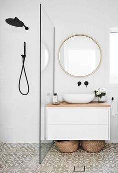 a bathroom with a sink, mirror and shower head in the middle of the room