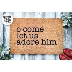 a door mat with the words o come let us adore him and red shoes