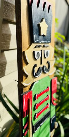 a close up of a wooden sign with a mustache