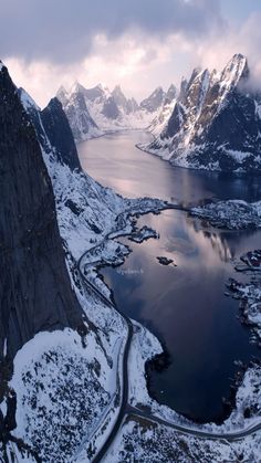 an aerial view of snow covered mountains and lakes in the middle of winter, looking down on a large body of water