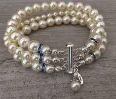 two bracelets with white pearls and blue beads