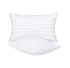 two pillows and one pillow with white stripes on the front, both are folded up