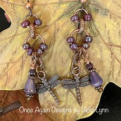 “Midsummer Eve Flight” - Dangle Earrings Hand Created - Once Again Designs By Vicki Lynn Limited Edition Dragonfly Earrings Reminiscent Of A Midsummer Eve. Iridescent Purple Glows In A Bath Of Warm Copper. This Pair: - Small Iridescent Purple Glass Beads. - Czech Glass Purple Bead Drops. - Copper Tone Metal Dragonfly Charm And Findings. - Tierracast Niobium Hypoallergenic French Hook Ear Wires With Copper Bead. - Length: Approximately 2-1/2” From Top Of Ear Wire To The Longest Bead Drop- Package Fairy Style Jewelry, Unique Purple Earrings With Dangling Beads, Purple Bohemian Earrings For Beach, Purple Beaded Dangle Earrings For Beach, Purple Dangle Beaded Earrings For Beach, Lavender Dangle Earrings Hypoallergenic, Purple Dangle Earrings For The Beach, Purple Dangle Earrings For Beach, Bohemian Lavender Earrings With Dangling Beads