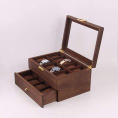 an open wooden jewelry box sitting on top of a table