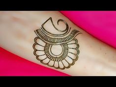 a woman's arm with a henna tattoo on it