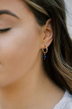 Trendy everyday hoops with a pop of color. These dainty hoop earrings feature a genuine lapis lazuli stone. Lapis lazuli is a deep blue semi-precious stone considered the universal symbol of wisdom and truth. These hoop earrings are available in your choice of 14k gold filled or sterling silver. The hoops have an easy to open and close latch top. The total drop on these earrings is about 1 inch. Your new earrings will arrive in a complimentary gift box. To see other jewelry from Austin Down to E Blue Huggie Hoop Earrings For Pierced Ears, Blue Huggie Single Earring, Blue Huggie Hoop Earrings For Everyday, Blue Small Hoop Earrings With Matching Set, Everyday Blue Huggie Hoop Earrings, Elegant Blue Huggie Earrings For Everyday Wear, Blue Huggie Earrings For Everyday, Elegant Blue Hoop Earrings For Everyday, Blue Small Hoop Earrings