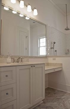 a bathroom with two sinks and a large mirror