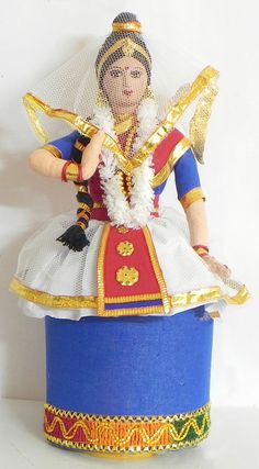 a figurine is sitting on top of a blue box with gold trimmings