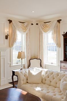 a living room filled with furniture and windows