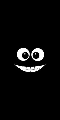 the face of an evil looking monster with large eyes and big, white teeth on a black background