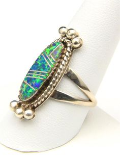 - Beautiful vintage inlay sterling silver and opal ring in size 10- Ring is signed "Sterling, M" likely for Navajo artisan Lennie Mariano- Ring face measures 1.23" tall by .45" wide and .17" deep- Ring weighs 7 grams Silver Opal Ring With Inlay For Anniversary, Anniversary Silver Opal Ring With Inlay, Unique Sterling Silver Opal Inlay Ring, Unique Sterling Silver Opal Ring With Inlay, Southwestern Silver Opal Ring In Sterling Silver, Vintage Silver Multi-stone Opal Ring, Collectible Sterling Silver Opal Ring Stamped 925, Oval Opal Ring With Inlay For Gift, Artisan Sterling Silver Oval Opal Ring