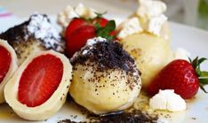 some desserts are on a plate with strawberries