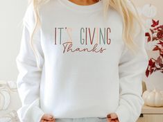 🍂 Get ready to embrace the cozy spirit of the season with our cute fall sweatshirt, perfect for Thanksgiving gatherings and Friendsgiving celebrations. 🦃 This "It's Giving Thanks" sweatshirt not only highlights your grateful heart but also adds a stylish touch to your fall outfit. 🍁 Made for comfort, this thankful sweatshirt is your go-to piece for chilly autumn days. ❄️ Whether you're enjoying a family dinner or just want to feel snug at home, our Thanksgiving sweatshirt is a wonderful remin Thanksgiving Addition, Thankful Sweatshirt, Thanksgiving Sweater, Friends Thanksgiving, Thanksgiving Sweatshirt, Giving Thanks, Sweater Autumn, Autumn Days, Grateful Heart