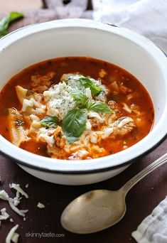 a white bowl filled with soup on top of a wooden table