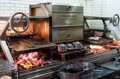 an industrial kitchen with grills and cooking utensils on the burners in front of them