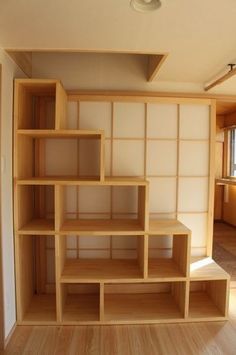 an empty room with wooden shelves in it