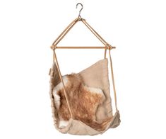 a hammock hanging from a rope with a furry animal in the pocket on it