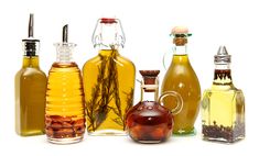 several different types of oils and bottles on a white background