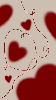 several red hearts are flying in the air with strings attached to them, as if for valentine's day or other special occasion