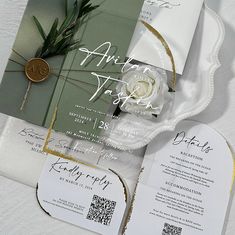 the wedding stationery is laid out on top of each other