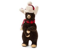 a stuffed bear wearing a red and black scarf, hat and scarf around it's neck