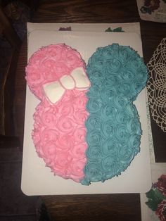 there is a large cake with pink and blue frosting in the shape of a bear