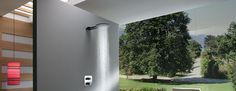 a modern bathroom with an open shower head and large window overlooking the trees in the background