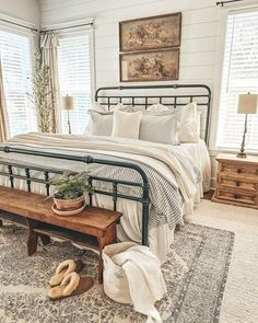 a bed room with a neatly made bed and a wooden bench in front of it