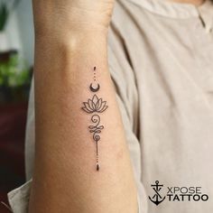 a woman's arm with a tattoo on it that has a flower and a crescent