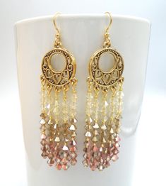 CAPRI GOLDEN OMBRE Crystal Chandelier Earrings Capri Golden Ombre Crystal Long Earrings  Capri Golden Ombre Crystal Chandelier Earrings Gorgeous, high-quality Austrian faceted bicone crystals. I used tiny gold seed beads for spacers and antique gold-finished heart cut-out design chandelier components. You will certainly make a statement with these stunning earrings.    Earring lengths: Drop length is 2.5" (total length is 3.0") 4mm faceted, bicone high quality Austrian crystals Tiny gold spacer Gold Bohemian Chandelier Earrings With Dangling Beads, Gold Crystal Earrings With Dangling Beads, Gold Beaded Teardrop Chandelier Earrings, Bohemian Gold Crystal Earrings For Party, Gold Bohemian Dangle Chandelier Earrings, Bohemian Gold Dangle Chandelier Earrings, Golden Ombre, Crystal Chandelier Earrings, Heart Cut Out