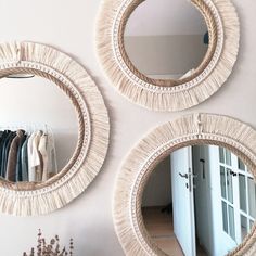 three circular mirrors are hanging on the wall