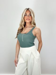 Introducing our Daylight Bodysuit - an elevated and chic essential for spring. Made from ribbed, soft, and stretchy material, with hidden snap closures and snap button details for a sleek and comfortable fit. Its thong design makes it perfect for layering, while its neutral and muted tones make it versatile for dinner or drinks. A must-have staple in any fashion-forward wardrobe. 73% Viscose 27% Nylon Hand wash cold separately. Solid Color Everyday Bodysuit For Spring, Chic Bodysuit For Everyday Wear, Chic Solid Color Bodysuit For Everyday, Chic Fitted Everyday Bodysuit, Chic Everyday Fitted Bodysuit, Trendy Stretch Bodysuit With Button Closure, Summer Everyday Bodysuit, Chic Cotton Bodysuit For Spring, Casual Spring Bodysuit With Button Closure