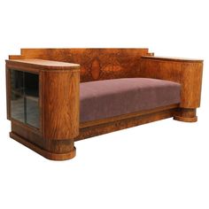 a wooden bench with purple upholstered cushion and glass doors on the back side