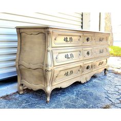 an old dresser is sitting outside in front of a building