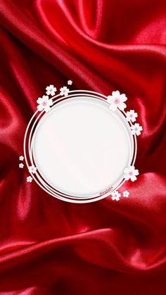 a white plate sitting on top of a red satin covered table cloth with an empty space in the center