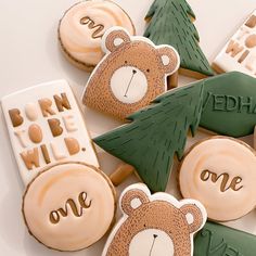 decorated cookies are arranged in the shape of trees and teddy bears with words on them